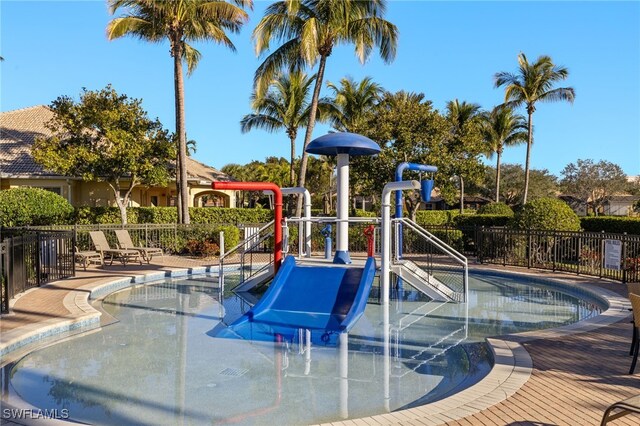 view of swimming pool featuring a playground