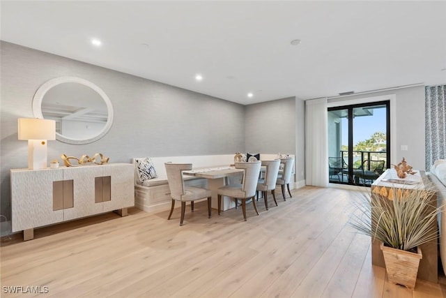 dining space with wood finished floors and recessed lighting