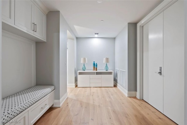 bedroom with baseboards, light wood-type flooring, and visible vents