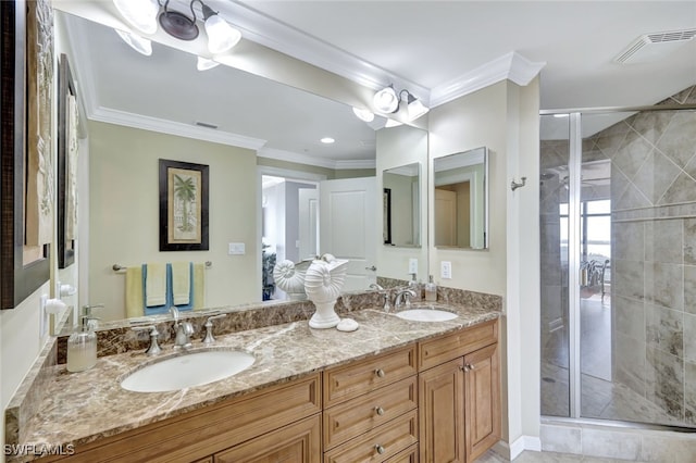 bathroom with vanity, crown molding, and a shower with shower door