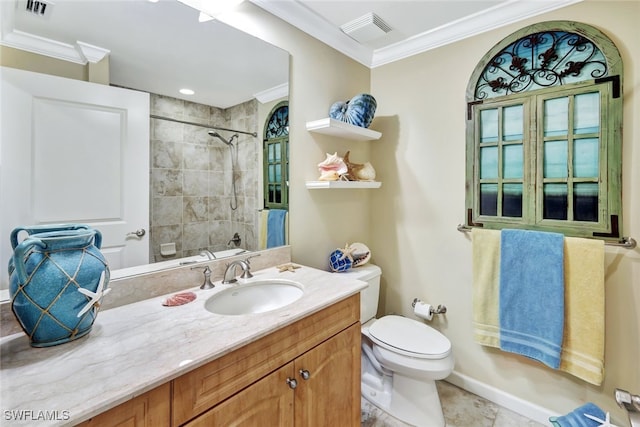 full bathroom featuring ornamental molding, tiled shower / bath, vanity, and toilet