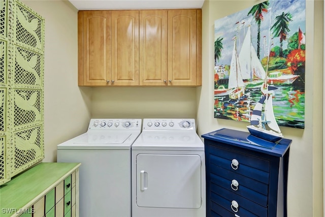 washroom featuring cabinets and separate washer and dryer