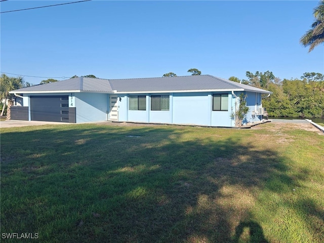 ranch-style home with an attached garage and a front lawn