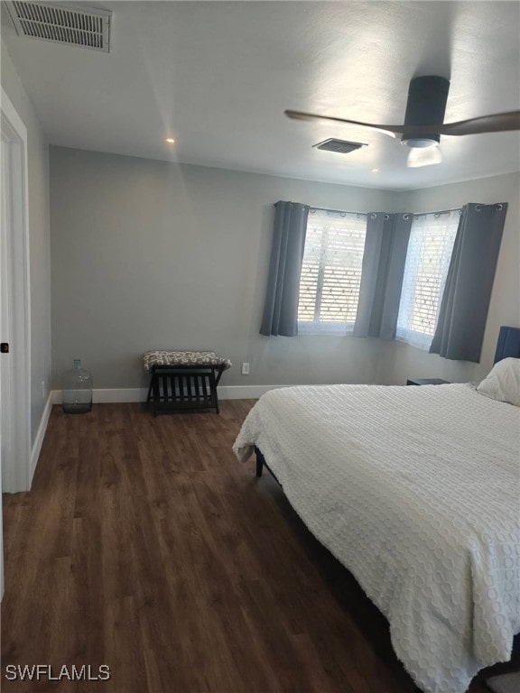 bedroom with dark hardwood / wood-style flooring