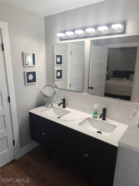 bathroom featuring tasteful backsplash, hardwood / wood-style floors, and vanity