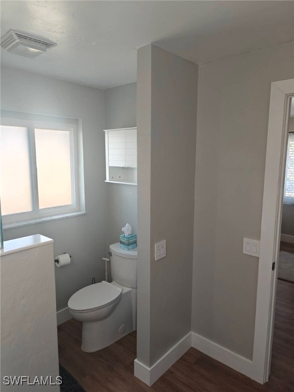 bathroom featuring hardwood / wood-style flooring and toilet