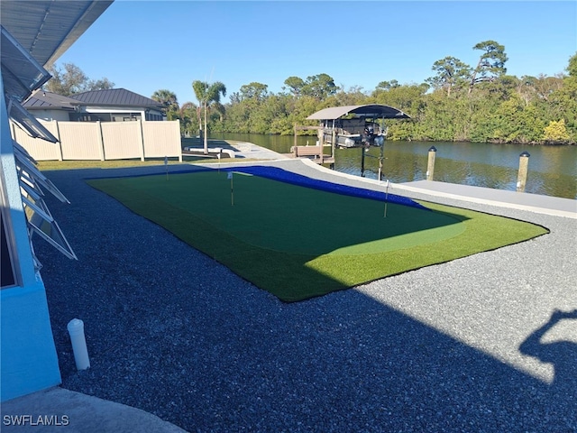 view of yard featuring a water view and a boat dock