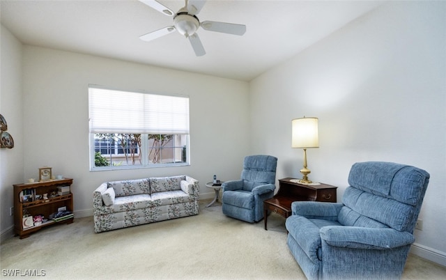 living area featuring carpet floors and ceiling fan