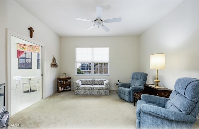 carpeted living room featuring ceiling fan