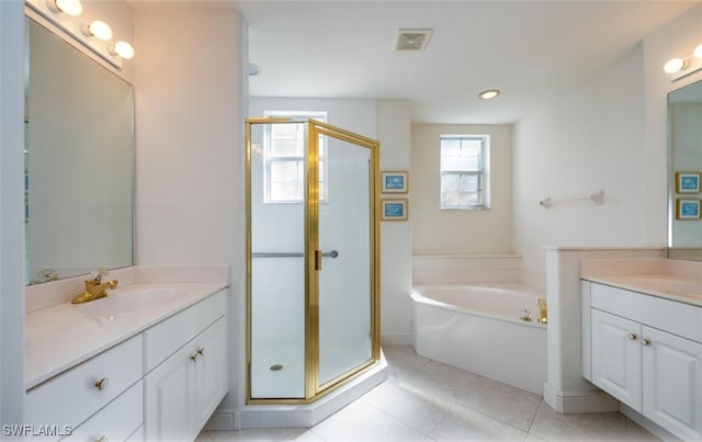 full bathroom with a sink, two vanities, a stall shower, and visible vents