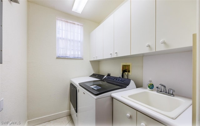 laundry area featuring cabinets, light tile patterned flooring, sink, and independent washer and dryer