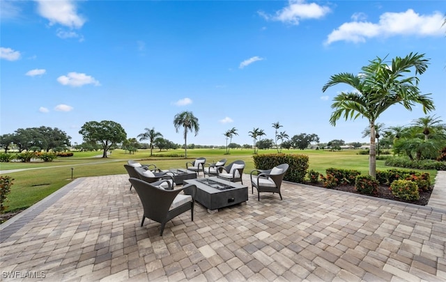 view of patio with view of golf course and an outdoor fire pit