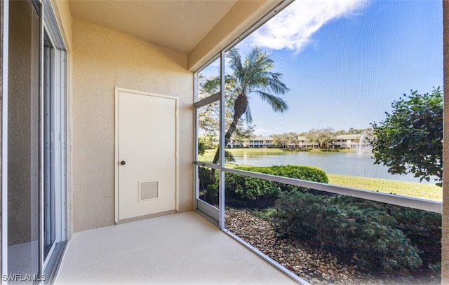 unfurnished sunroom featuring a water view and visible vents