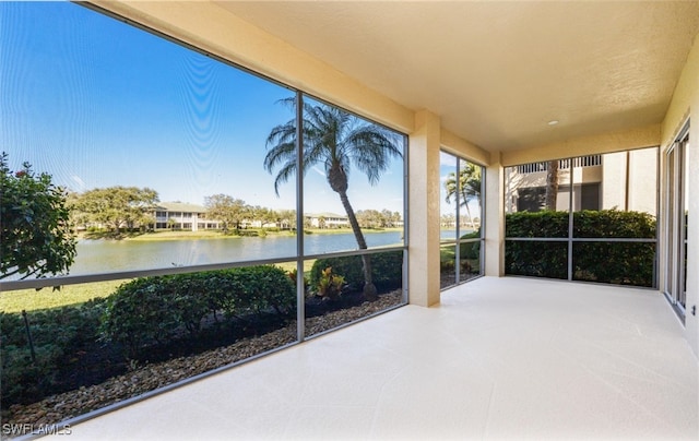 unfurnished sunroom with a water view