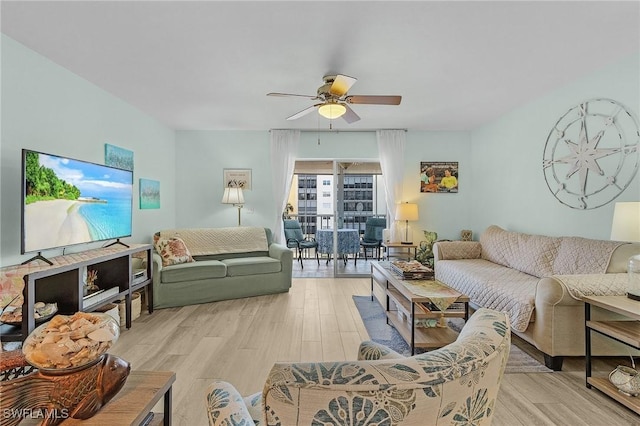 living room with ceiling fan and light wood-type flooring