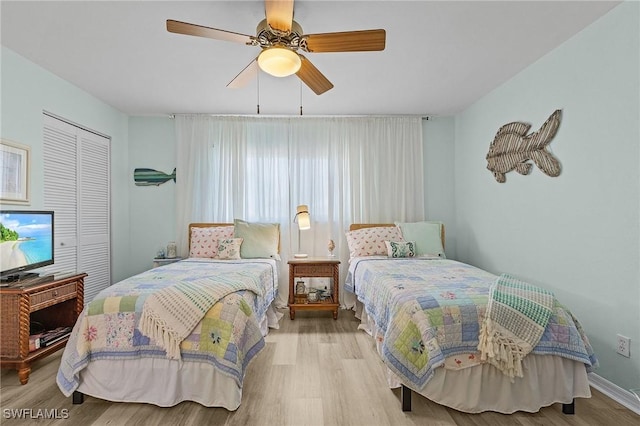 bedroom featuring ceiling fan, a closet, and light hardwood / wood-style flooring