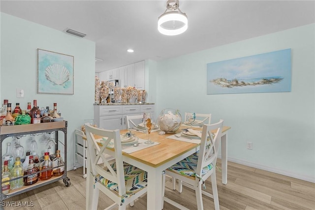 dining area with light hardwood / wood-style floors