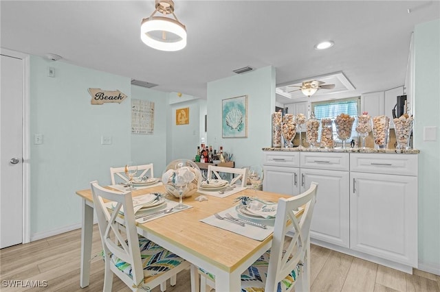 dining room with ceiling fan and light wood-type flooring