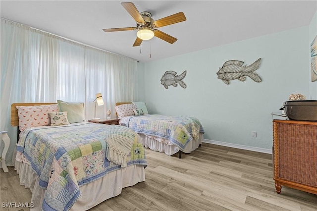 bedroom featuring light hardwood / wood-style floors and ceiling fan