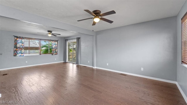 empty room featuring a ceiling fan, baseboards, and wood finished floors