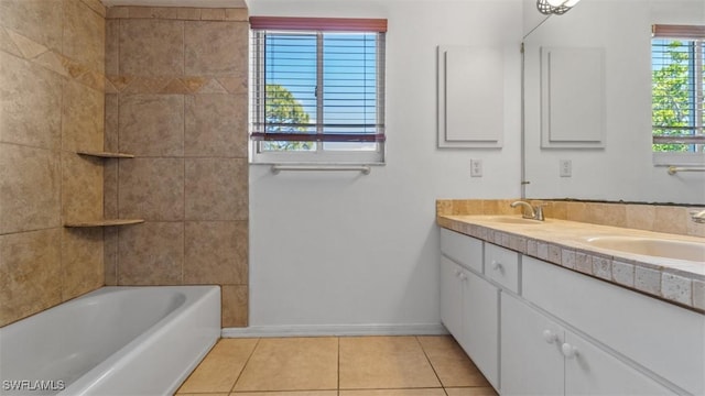 full bathroom with double vanity, baseboards, a sink, and tile patterned floors