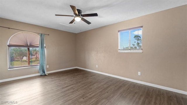 unfurnished room featuring a ceiling fan, baseboards, and wood finished floors