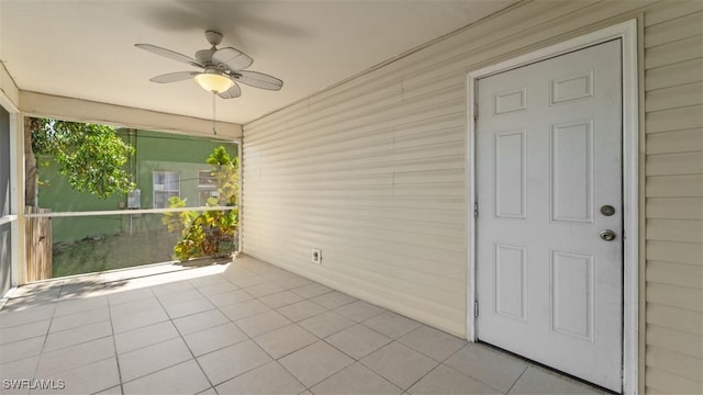 unfurnished sunroom with a ceiling fan