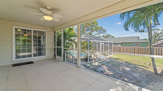 unfurnished sunroom with a ceiling fan