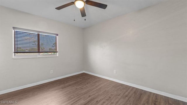 unfurnished room featuring ceiling fan, baseboards, and wood finished floors