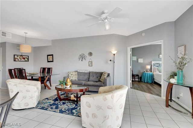 tiled living room with ceiling fan