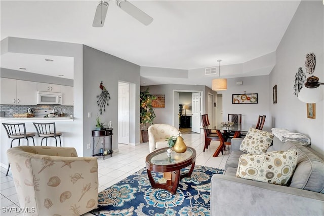 living room with light tile patterned flooring and ceiling fan