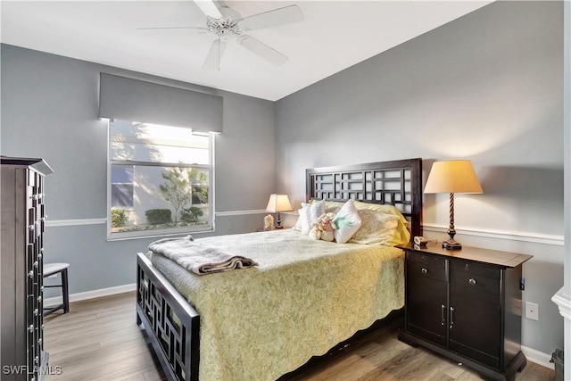 bedroom with hardwood / wood-style flooring and ceiling fan