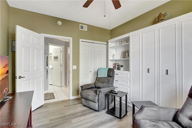 sitting room featuring ceiling fan and light wood-type flooring