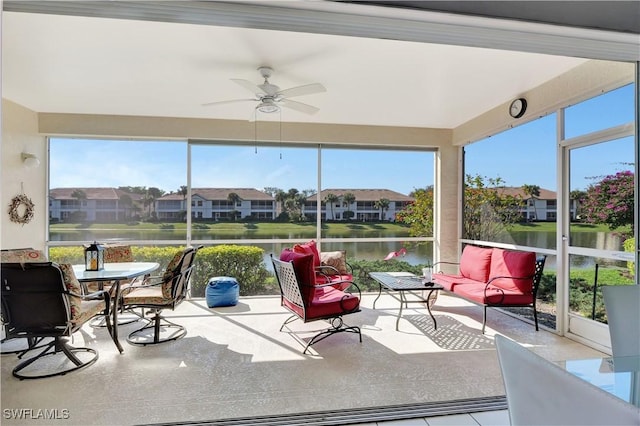 sunroom / solarium with a water view and ceiling fan