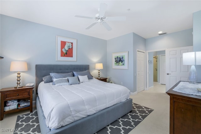 carpeted bedroom with ceiling fan and a closet