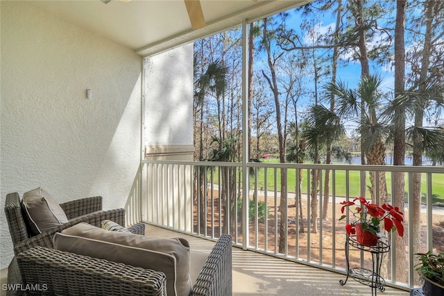 sunroom / solarium featuring a water view