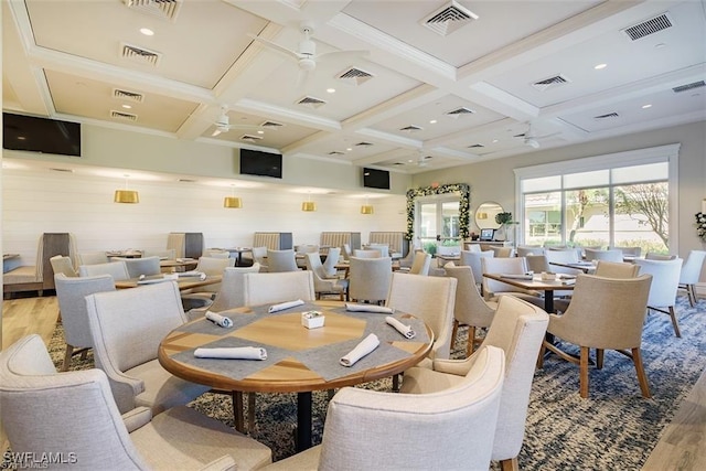 dining area with coffered ceiling, beam ceiling, ceiling fan, and light wood-type flooring