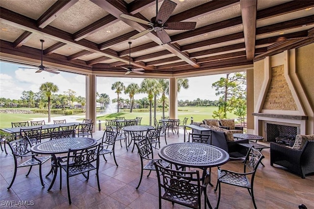 view of patio featuring a gazebo, a fireplace, and ceiling fan