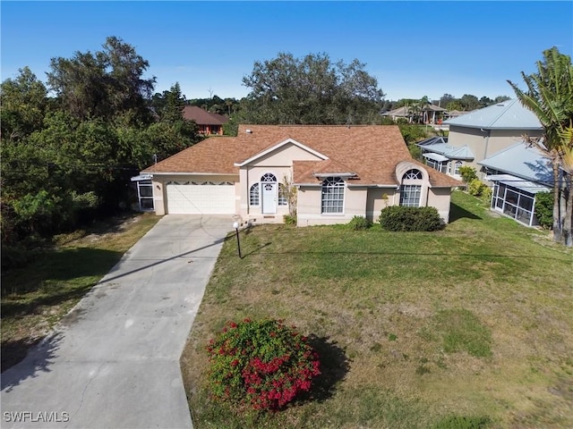 ranch-style home featuring a garage and a front yard