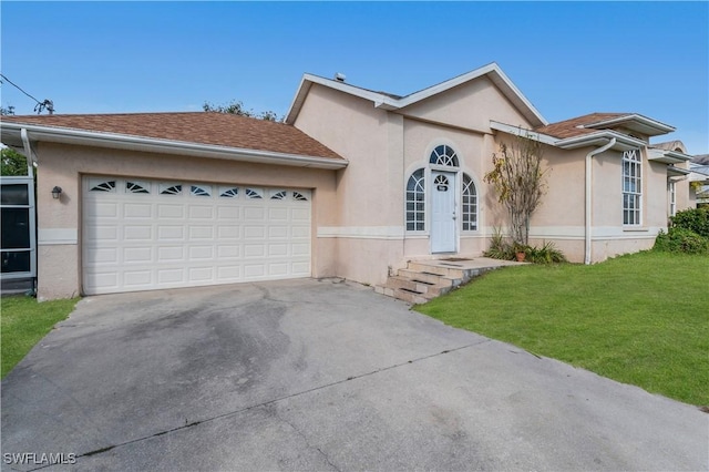 ranch-style house featuring a garage and a front yard