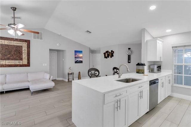 kitchen featuring white cabinetry, dishwasher, lofted ceiling, sink, and kitchen peninsula