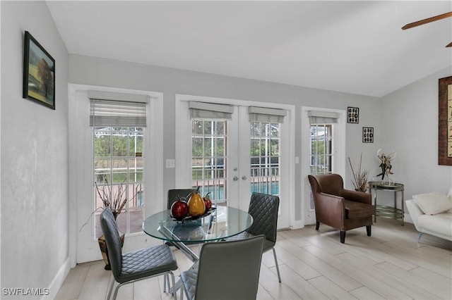 dining area featuring french doors, light wood-type flooring, and a wealth of natural light