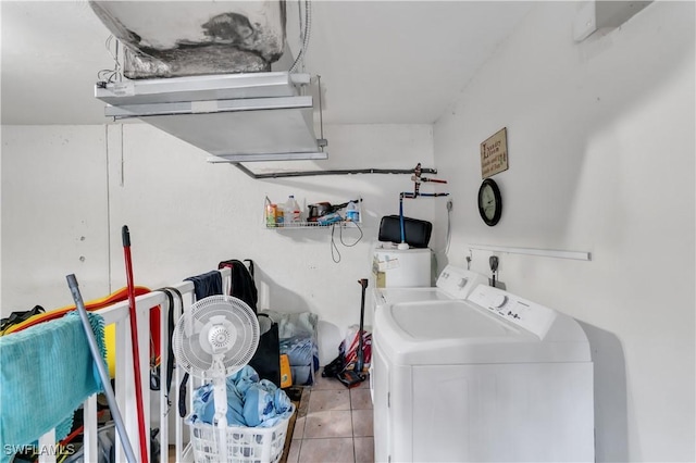 washroom featuring washing machine and dryer and light tile patterned floors