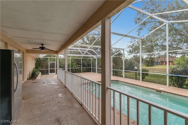 exterior space with ceiling fan and glass enclosure