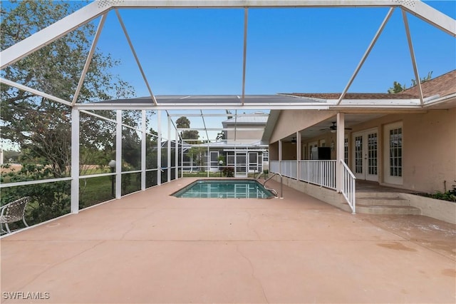 view of pool with a patio area, french doors, ceiling fan, and glass enclosure