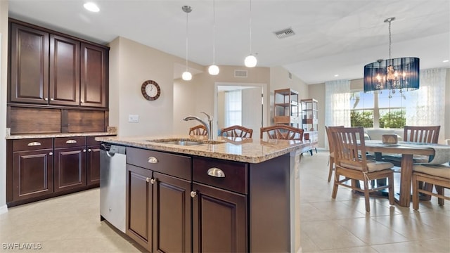 kitchen with pendant lighting, sink, dark brown cabinets, a center island with sink, and stainless steel dishwasher