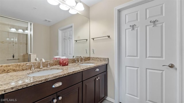 bathroom featuring an enclosed shower and vanity