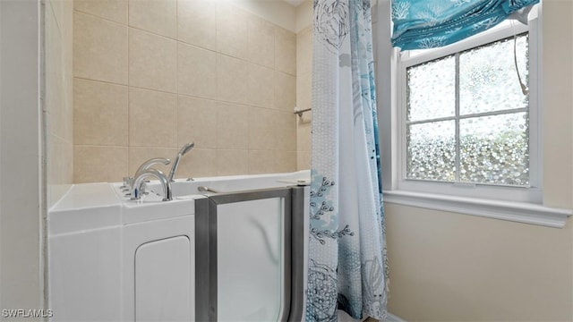 clothes washing area with tile walls