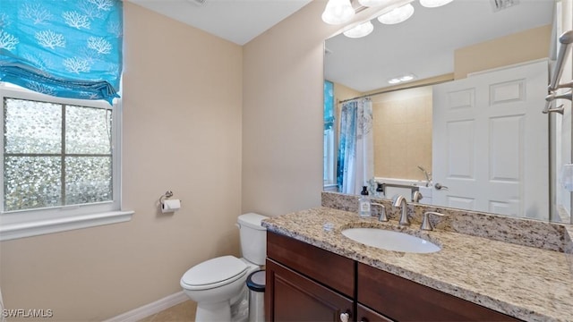 bathroom featuring vanity, toilet, and a shower with shower curtain