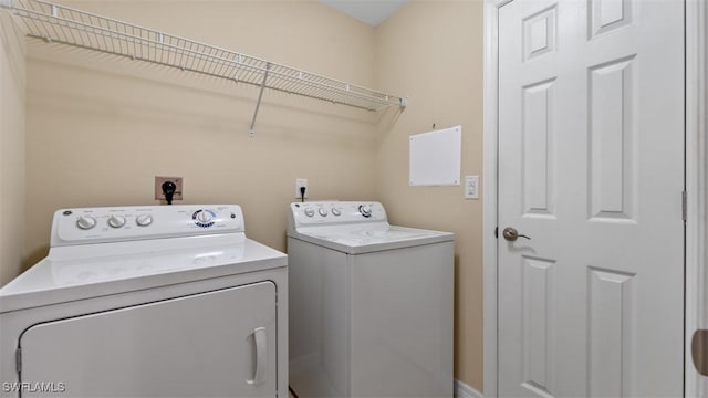 washroom with washer and dryer